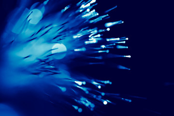 fiber optic cable blue light for super high speed communication tech background