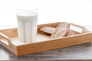 Cooking base kitchen concept. Morning milk glass. Buttermilk dairy drink breakfast on wooden desk. Bread, butter. 