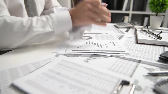  Angry businessman has stress and troubles with bad reports, he breaks documents and throws it.