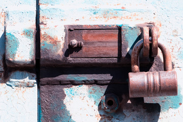 Old deadbolt with padlock.