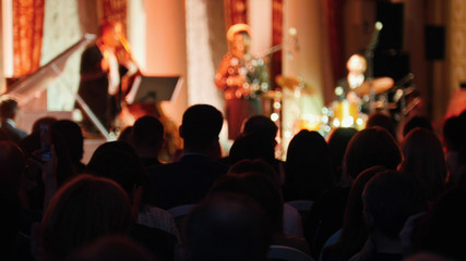 The audience watching a jazz concert in the concert hall