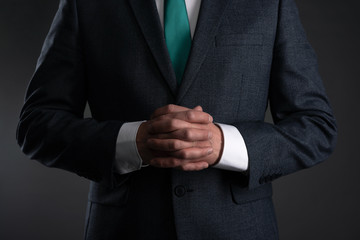 Businessman with a crossed arms on a gray background. Business acumen. Strict boss.