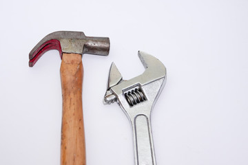 Adjustable spanner and hammer tool against white background.