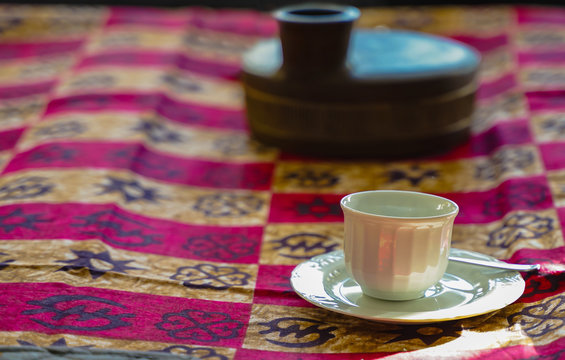 Closeup image of one white cup of coffee on table in an african coffee. perfect day and relax moment - Image