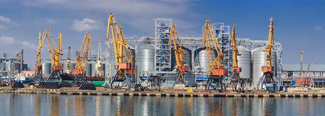 Lifting cargo cranes, ships and grain dryer in Sea Port of Odessa, Black Sea, Ukraine - obrazy, fototapety, plakaty