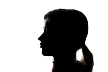 Dark silhouette profile of a young girl on a white background, the concept of anonymity