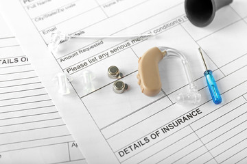 Hearing aid with accessories on doctor's table