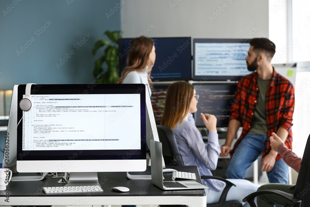 Poster team of programmers working in office
