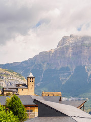 Fototapeta premium Torla Ordesa, church with the mountains at bottom, Pyrinees Spain vertical