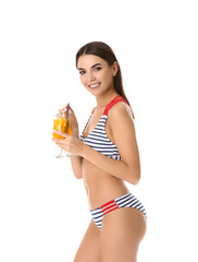 Beautiful young woman in swimming suit and with cocktail on white background