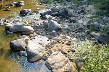 Rocks in various sizes in a river water stream in natural park