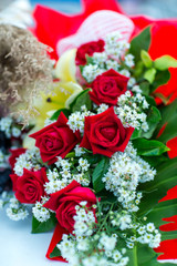Valentines day background. Beautiful bouquet of roses on wooden table . Luxury bouquet made of red roses in flower shop Valentines Bouquet of red roses.  Rose bouquet. Soft focus of a Rose .