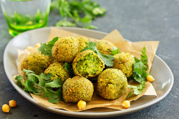 Fresh falafel balls on a dark background.