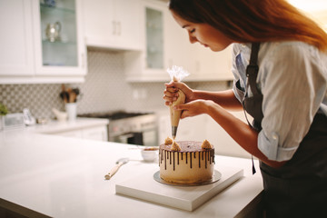 Pastry chef decorating chocolate cake