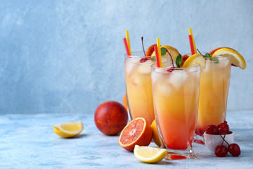 Glasses of Tequila Sunrise cocktail on table