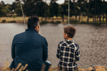 Father and son spending time together fishing in a lake