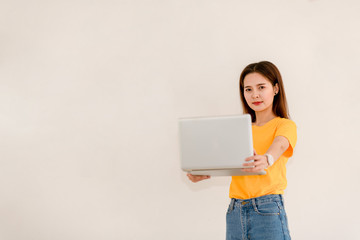 Smile Asian girl holding a laptop computer separately on a white background.