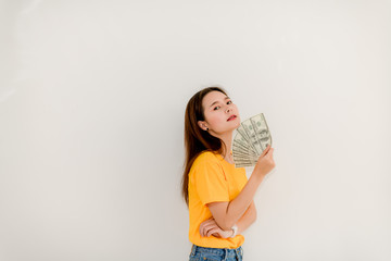Beautiful Asian girl holding money separately on white background Asian Girls Counting Dollars Save Salaries Succeeded in financial business