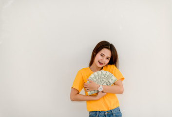 Beautiful Asian girl holding money separately on white background Asian Girls Counting Dollars Save Salaries Succeeded in financial business