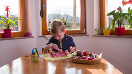 Child painting Easter eggs