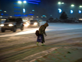 Busy city street people on zebra crossing at night. Dangerous situation