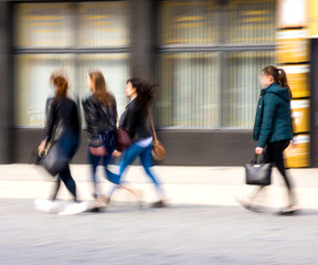 Busy city people going along the street. Intentional motion blur