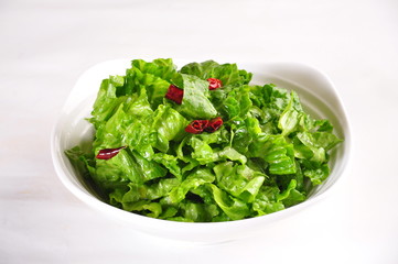 fresh green salad in a bowl isolated on white