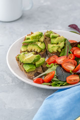 Healthy Breakfast with avocado toasts and salad