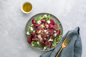 Beetroot salad with feta cheese, arugula and walnuts, top view