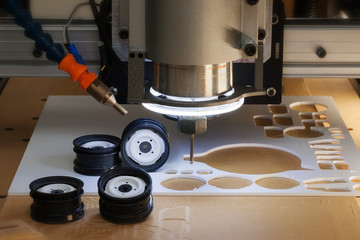 Desktop CNC machine used to make scale model rims and wheels from ABS plastic material.