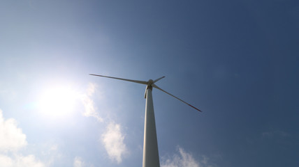 Fototapeta premium Wind turbines for electric power production on beautiful sunny summer with blue sky. Green ecological power energy generator.