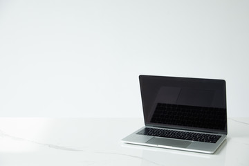 laptop with blank screen and black keyboard isolated on grey
