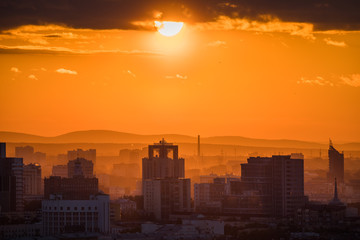 Fototapeta na wymiar Ekaterinburg, Russia - Jule, 2018: Telephoto lens panoramic shot of cityscape view megalopolis during sunset at summer evening