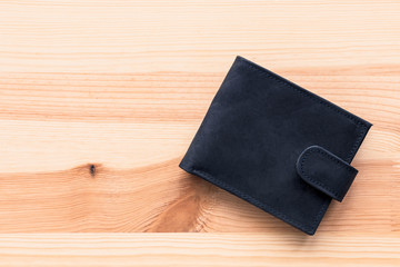 Stylish black leather male wallet on wooden table