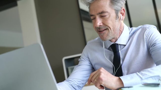 Businessman on video call in contemporary office
