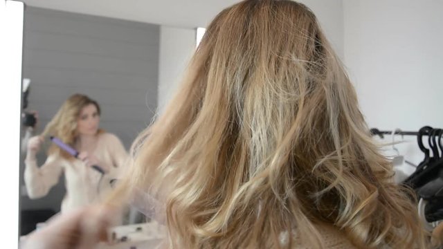 Young Blonde Woman Getting Hairstyle Long Hair With Iron In Hairdressing Salon HD stock footage