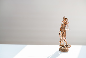 Statue of blind goddess Themis on blurred background