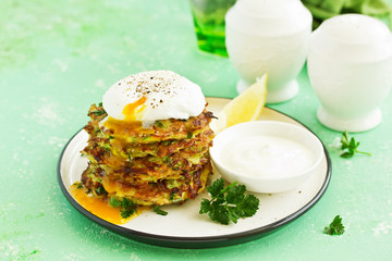 Zucchini fritters and peas with sour cream sauce and poached egg.