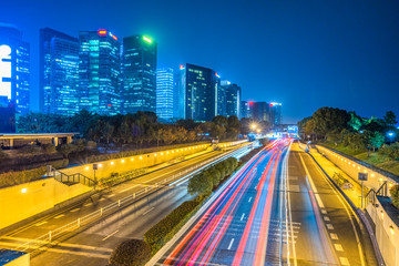 Fototapeta na wymiar traffic light through city at night in china