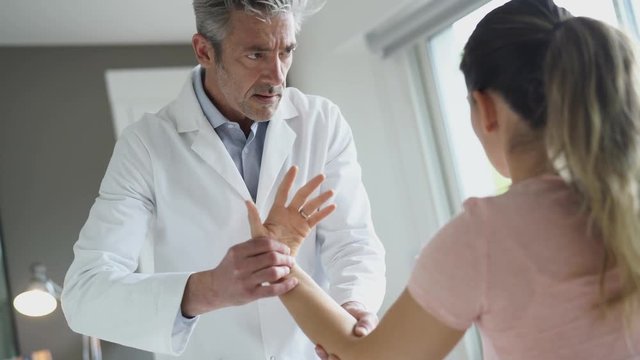 Physiotherapist working with patient's wrist injury