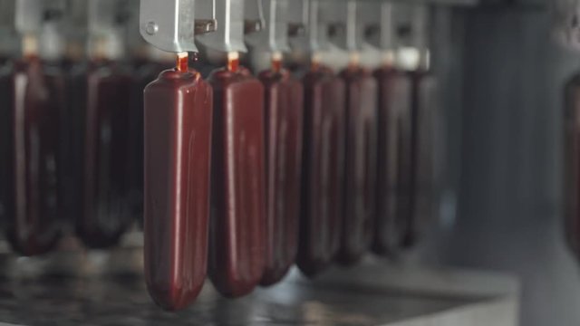 ice cream production, chocolate ice cream is transported on a conveyor, dairy products.