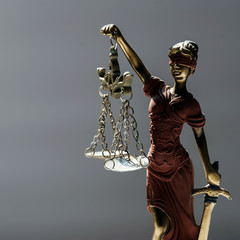 Statue of blind goddess Themis on blurred background