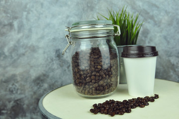 Fototapeta na wymiar coffee bean and hot coffee in paper glass
