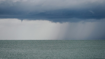 Seascape with rain in the distance