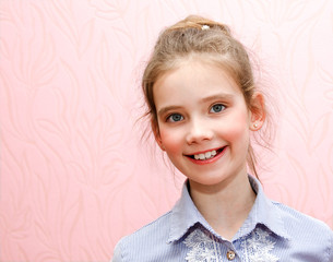 Portrait of adorable smiling little girl schoolgirl child isolated