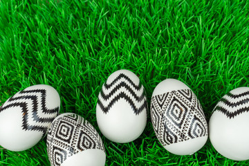 White eggs with black pattern in the grass