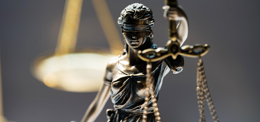 Statue of blind goddess Themis on blurred background