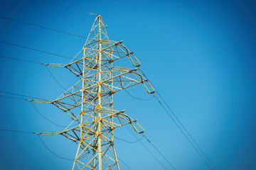 Electric pole with wires of high voltage against the sky.