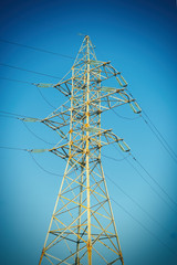 Electric pole with wires of high voltage against the sky.