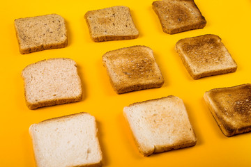 A selection of toast bread for breakfast. Minimalism on yellow